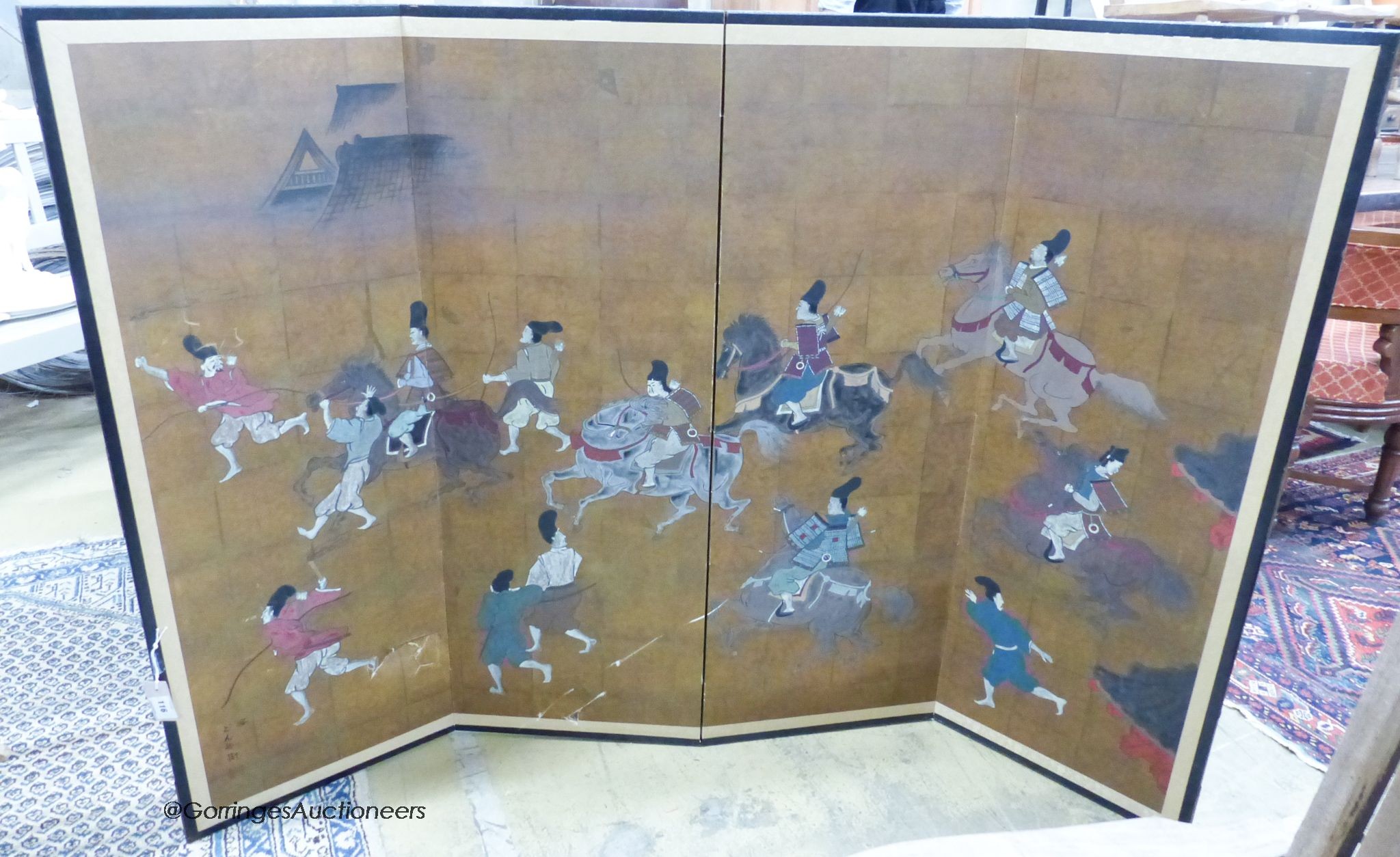 A Japanese four-fold screen, gold ground, decorated with warriors on horseback and foot, in black-lacquered and gilt metal round frame, each panel width 46cm height 122cm